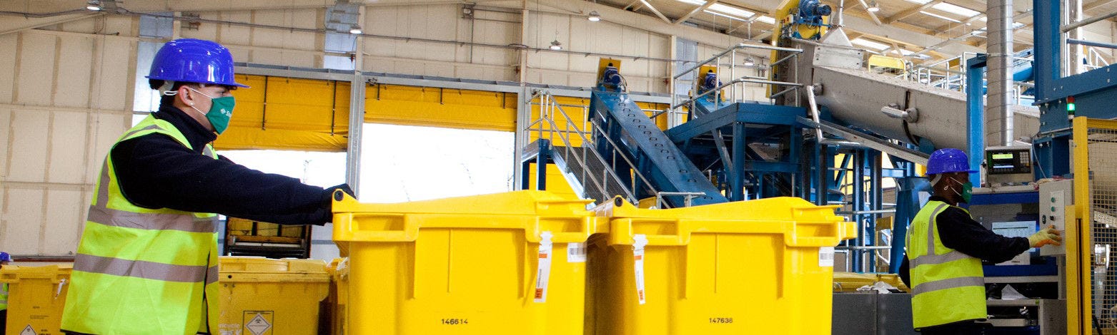 Man pushing Yellow Wheeled Bin