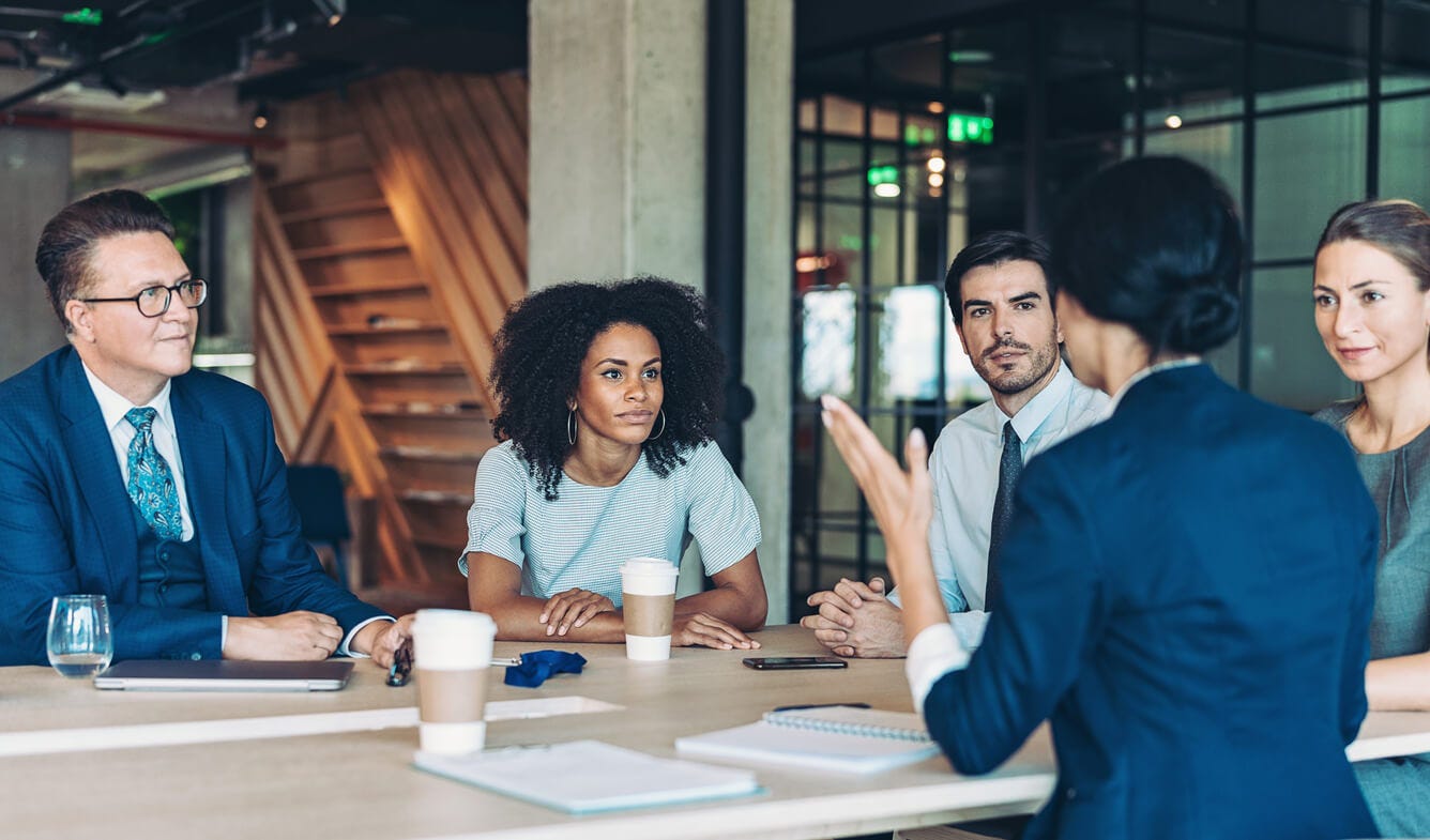 employees sitting around a table