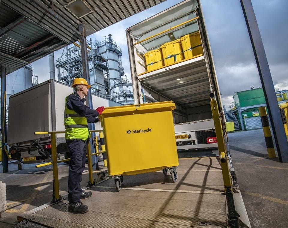 Driver loading wheeled unit in to lorry