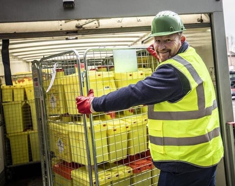 Stericycle employee collecting Bio Systems containers from a healthcare facility