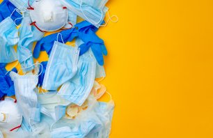 Protective equipment, masks and gloves, on an orange background, top view