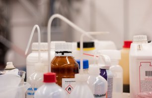 Various plastic bottle chemical containers in a science laboratory group shot shallow depth of field 2020